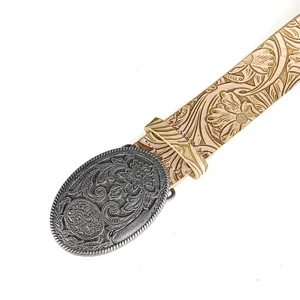 Close-up detail of western cowboy belt with floral engraved buckle and leather strap