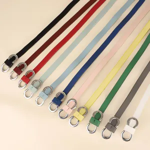 Collection of slim women's leather belts with silver figure-eight buckles in macaron colors