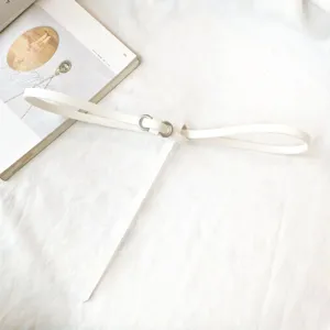 Detailed top-down view of a white minimalist thin belt with a silver metal buckle
