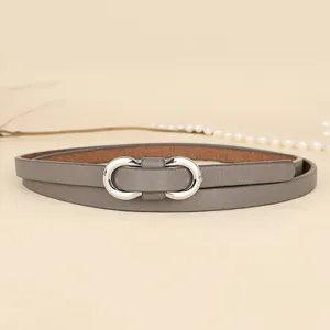 Detailed close-up of a minimalist grey thin leather belt with a silver infinity buckle