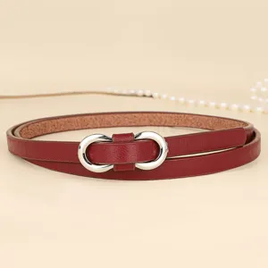 Detailed view of a slim red leather belt featuring a polished silver figure-eight buckle