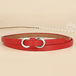 Close-up of metallic silver infinity buckle on a vibrant red thin leather dress belt