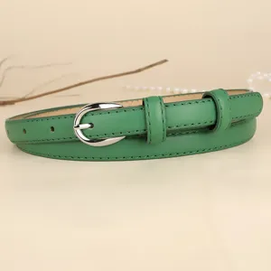 Detail of green skinny leather belt for women featuring a sleek silver pin buckle