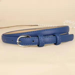 Detail view of a thin blue cowhide leather belt with a silver horseshoe buckle