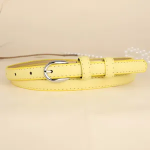 Detailed view of a slim yellow leather belt featuring a polished silver metal buckle
