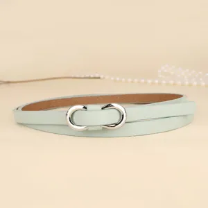 Close-up of a thin mint green women's waist belt with a silver double-ring buckle