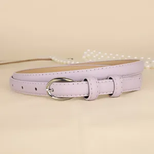 Detailed macro view of a light purple slim leather belt for women with elegant silver buckle