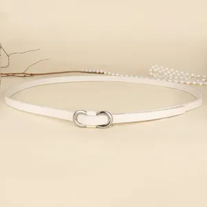 Detail of white minimalist women's thin belt with silver figure-eight buckle