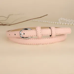 Close-up of a minimalist pink thin leather belt for women with silver buckle