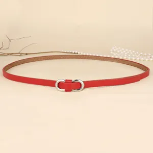 Close-up of red minimalist thin leather belt with a silver metal infinity buckle detail