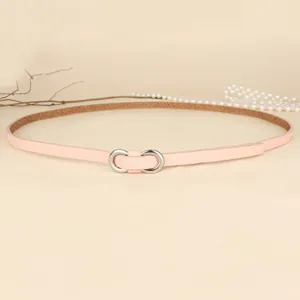 Close-up of minimalist macaron pink thin belt with silver infinity metal buckle.