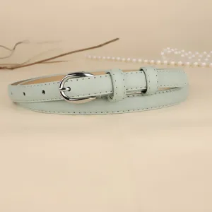 Close-up of minimalist mint green women's thin belt with silver buckle detail