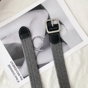 Grey woven stretch canvas belt with black pu leather ends and silver metal buckle detail