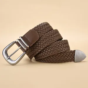 Close-up detail of a vintage metallic pin buckle on a textured brown PU woven belt