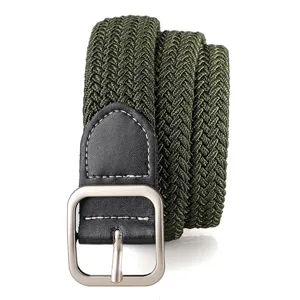 Close-up detail of army green woven elastic belt with silver metal buckle and leather tip.