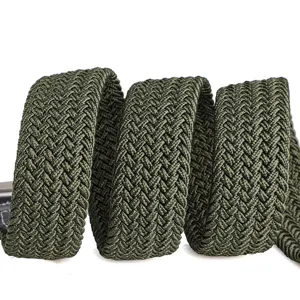 Green woven elastic belt detail showing textured braided pattern for casual trousers.