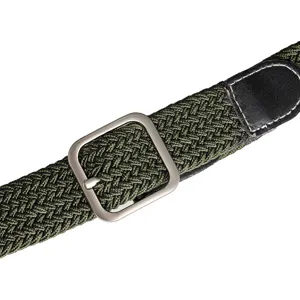 Army green braided elastic belt closeup, featuring a silver metal pin buckle and leather tip.