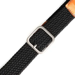 Close-up detail of the black woven elastic belt with silver buckle and leather accent.