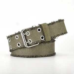 Distressed canvas belt detail shot, showing double metal grommets and frayed edge texture.