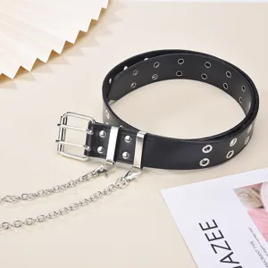 Close-up detail of punk style black leather belt with double grommets and metal chains.