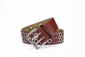 Detail shot of a dark red punk leather belt featuring metal grommets and a double buckle.