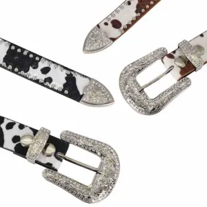 Western cow print rhinestone leather belt with ornate silver buckle and matching tip set.