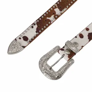 Cow print leather belt detail showing engraved silver buckle and studded edges for western style fashion.