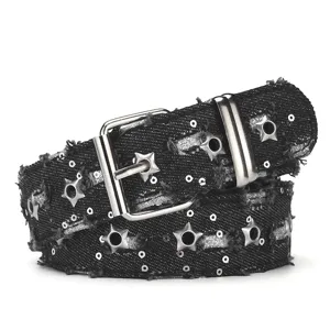 Punk style black denim star grommet belt detail featuring sequins and metal buckle.