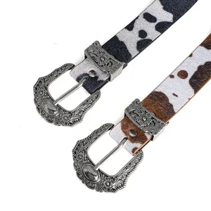 Vintage cow print belt with intricate carved metal buckle for women western fashion style