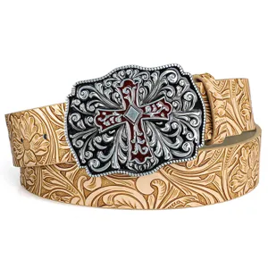 Close-up of vintage embossed leather belt featuring an ornate silver and red cross buckle