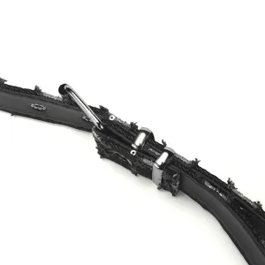 Distressed denim belt detail featuring punk style metal buckles and star studs for women.