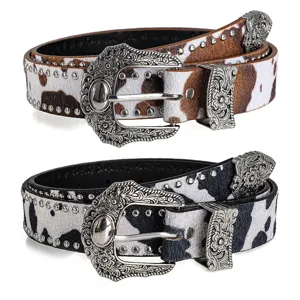 Vintage cow print leather belt set with ornate silver metal buckles and studded details.
