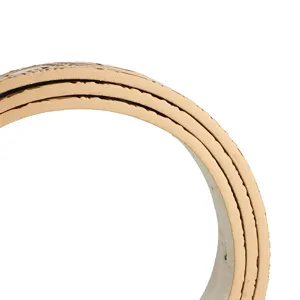 Macro view showing the intricate embossed phoenix pattern on a vintage beige leather belt