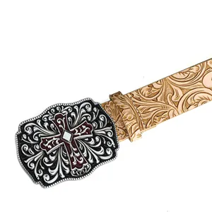 Detail view of vintage western belt with ornate cross buckle and embossed leather strap
