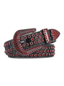 Close-up detail of black leather belt featuring sparkling red rhinestones and ornate metal hardware.