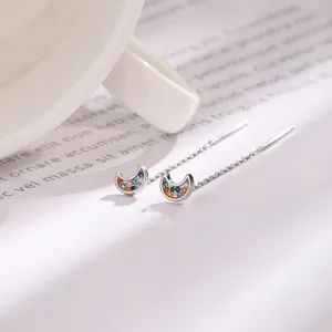 Detailed view of silver-plated crescent moon ear threaders with vibrant colored cubic zirconia