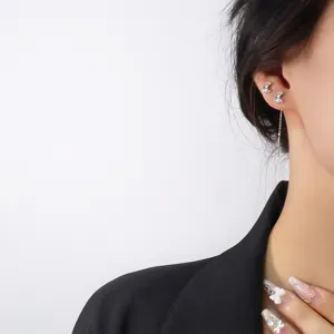 Close-up detail view of a colorful zircon crescent moon ear threader worn on a model ear