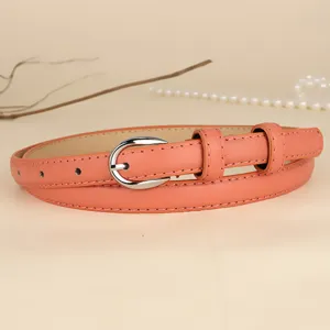 High-quality detail view of a salmon pink thin leather belt with silver U-shaped buckle