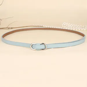 Close-up detail of a minimalist light blue thin leather belt with a silver figure-eight buckle