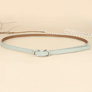 Detailed view of mint green skinny waist belt featuring a silver figure-eight metal buckle.