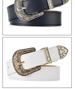 Detailed view of vintage western belts with ornate carved gold and silver buckles.