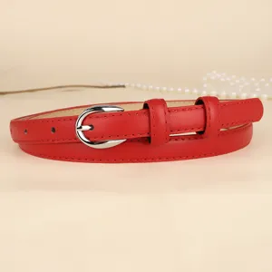 Close-up of a vibrant red slim leather belt with a sleek silver buckle on a neutral background.