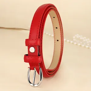 Close-up of elegant red skinny leather belt with polished silver-tone buckle for women