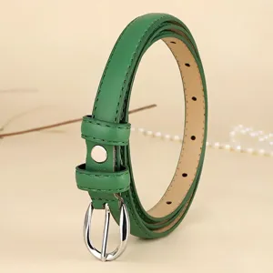 Detailed view of a retro green thin leather belt with silver buckle for women