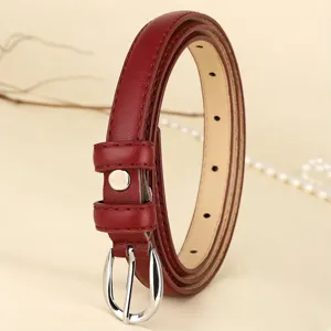 Detailed view of a vintage slim red leather belt for women with a polished silver buckle