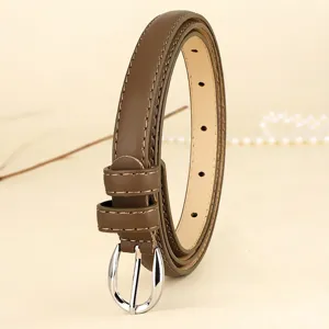 Close-up detail of a minimalist slim brown leather belt with elegant silver buckle