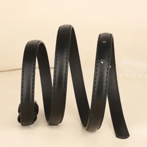 Close-up detail of a stylish coiled black minimalist thin leather belt for women