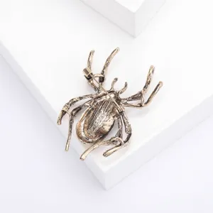 Detailed back view of an antique bronze spider brooch with a secure pin safety clasp