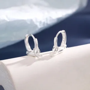 Detailed macro view of matte silver cat earrings with a cute stretching kitten design