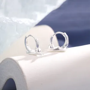 Macro view of matte silver cat-shaped hoop earrings with unique stretching design